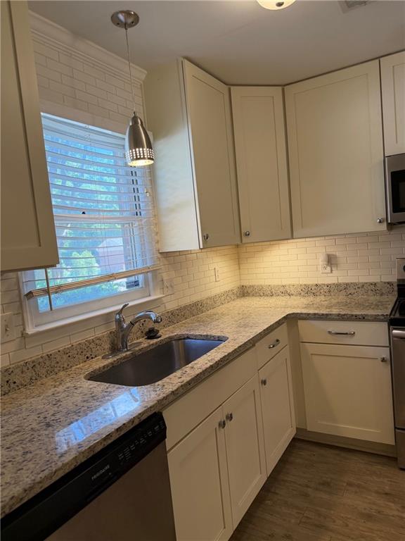 2912 Webb Bridge Road Alpharetta, GA 30009 - Photo 7 of 12 a kitchen with a sink and cabinets