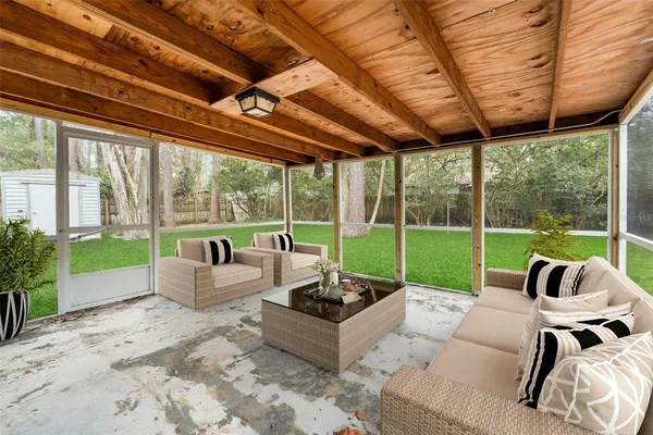 a view of a backyard of a house with a large tree