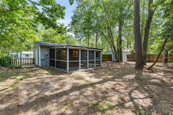 a view of a house with a tree in front of it