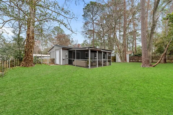 a view of a small house with yard