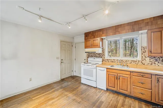 a kitchen with a stove a sink and a refrigerator