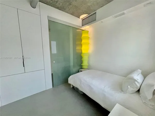 a bedroom with a bed and a closet