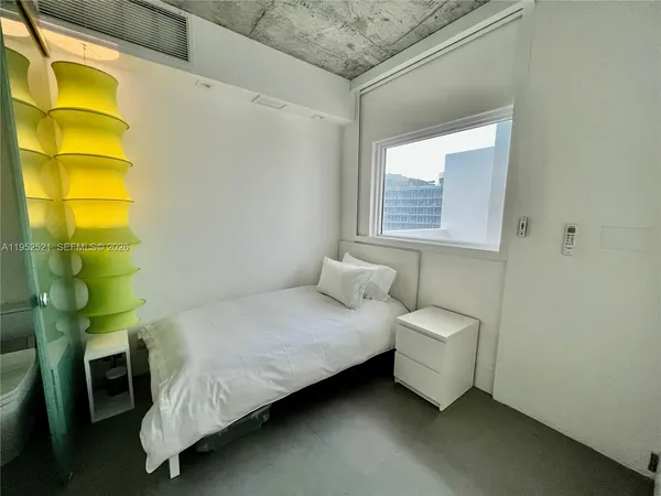 a bedroom with a bed and a chair