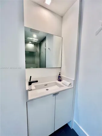 a bathroom with a sink and a mirror