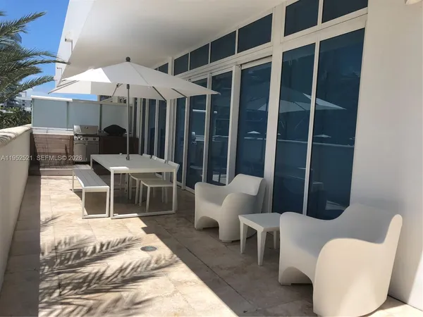 a balcony with furniture and a potted plant