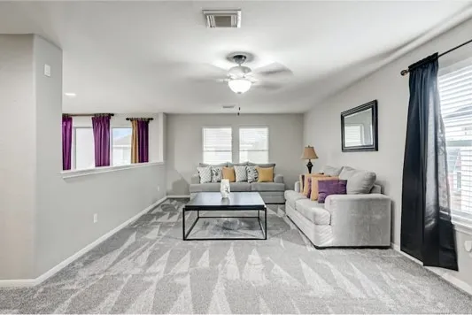 a living room with furniture and a large window