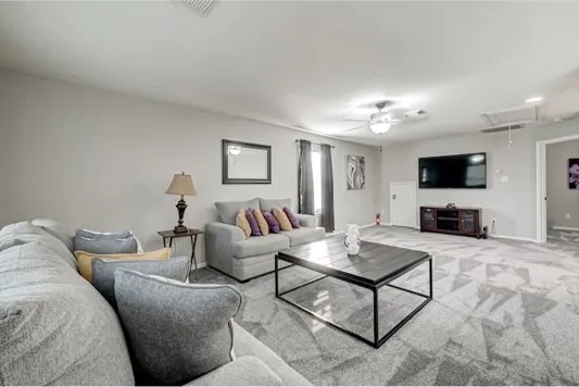 a living room with furniture and a flat screen tv