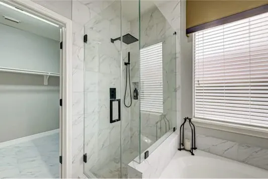 a bathroom with a tub and shower