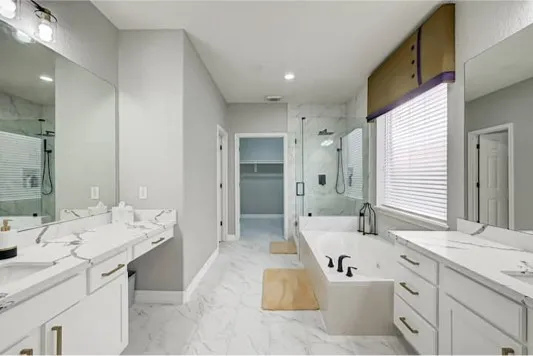 a spacious bathroom with a double vanity sink mirror and double