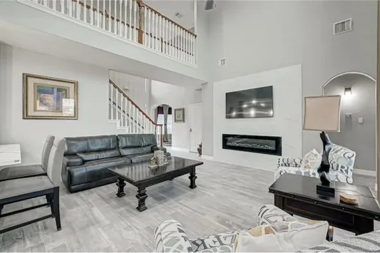 a living room with furniture and wooden floor