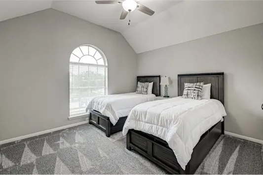 a spacious bedroom with a bed and a window