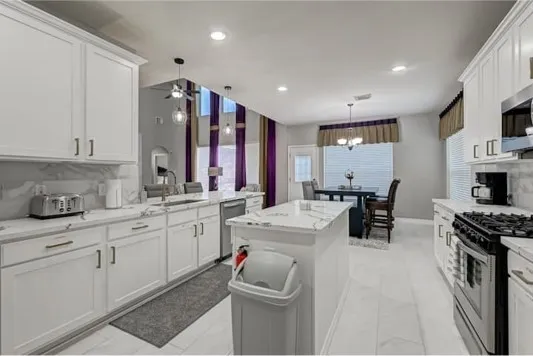 a kitchen with sink cabinets and appliances