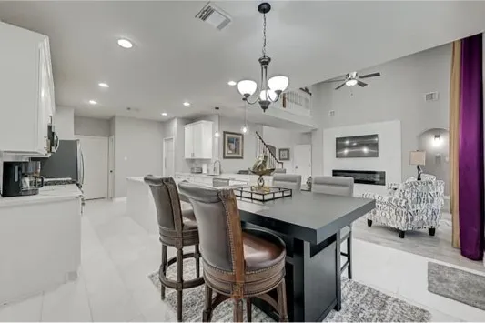 a view of a dining room with furniture and chandelier
