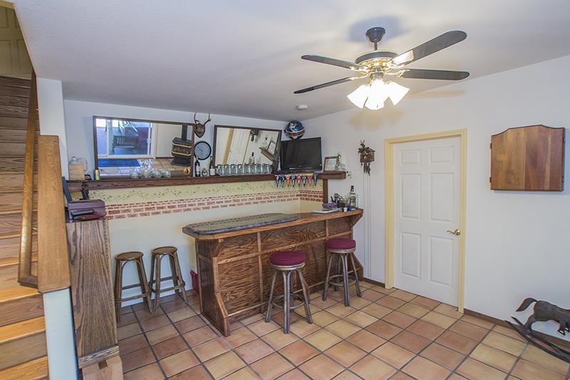 223 Ridge Road Woodside, CA 94062 - Photo 12 of 27 a room with furniture a fireplace and a chandelier