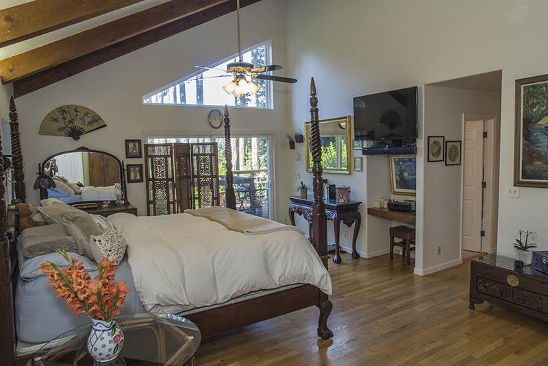 223 Ridge Road Woodside, CA 94062 - Photo 14 of 27 a bedroom with bed tv and wooden floor