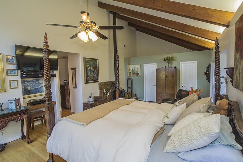 223 Ridge Road Woodside, CA 94062 - Photo 16 of 27 a bed room with a bed and a flat screen tv