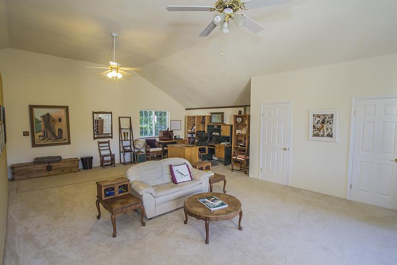 223 Ridge Road Woodside, CA 94062 - Photo 20 of 27 a living room with furniture and a chandelier