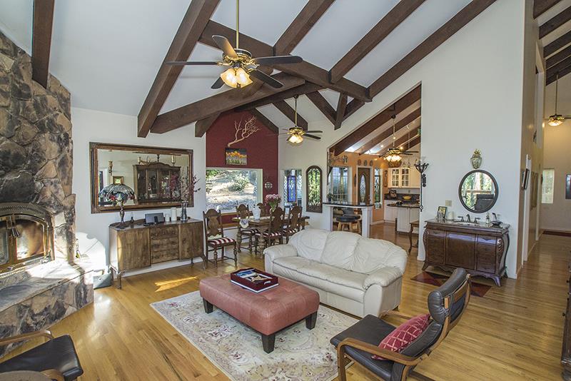 223 Ridge Road Woodside, CA 94062 - Photo 5 of 27 a living room with furniture and a chandelier