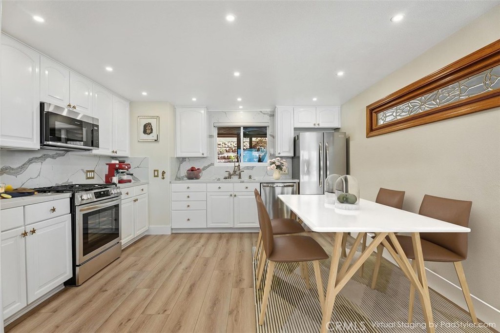 34381 Dana Strand Road Dana Point, CA 92629 - Photo 11 of 68 a kitchen with a table chairs a sink and a stove top oven