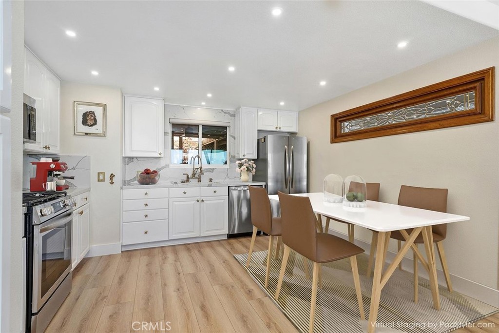 34381 Dana Strand Road Dana Point, CA 92629 - Photo 16 of 68 a kitchen with white cabinets and stainless steel appliances