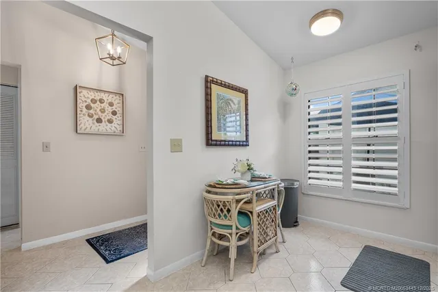 a dining room with a furniture and a window