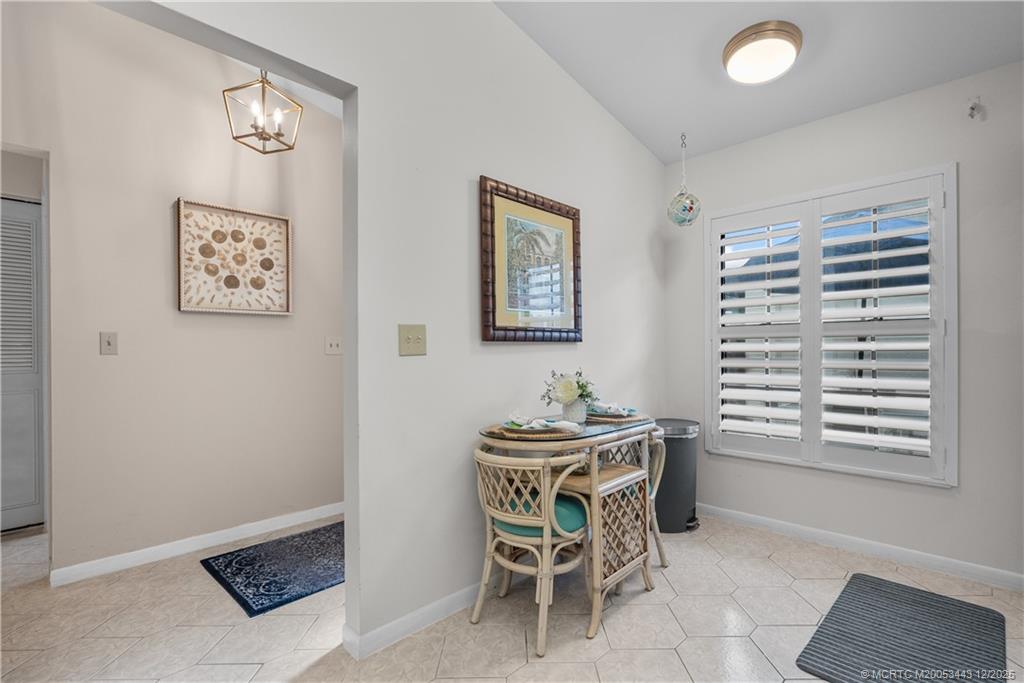 1544 Southwest Silver Pine Way, Unit 104F Palm City, FL 34990 - Photo 12 of 49 a dining room with a furniture and a window