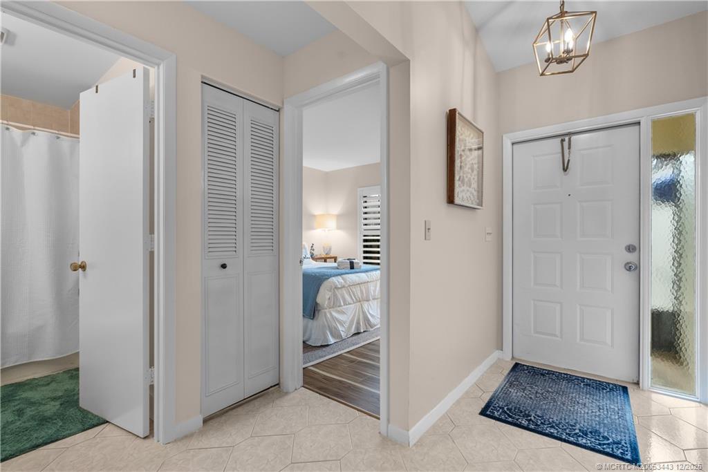 1544 Southwest Silver Pine Way, Unit 104F Palm City, FL 34990 - Photo 15 of 49 a view of a bedroom with closet and mirror