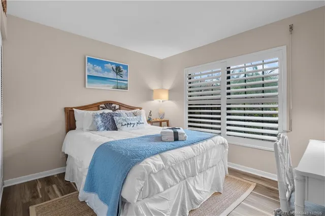 a bedroom with a bed and a painting on the wall