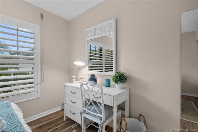 a view of a bedroom with furniture and window
