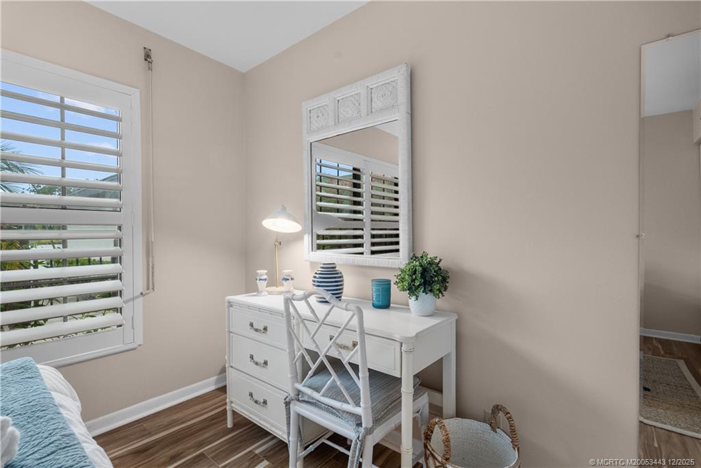 1544 Southwest Silver Pine Way, Unit 104F Palm City, FL 34990 - Photo 17 of 49 a view of a bedroom with furniture and window