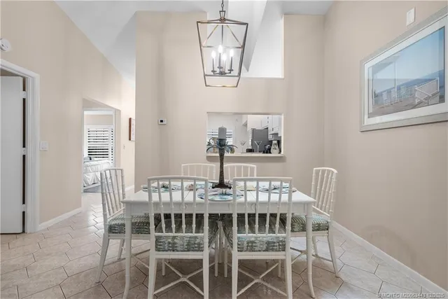 a view of a dining room with furniture and a chandelier