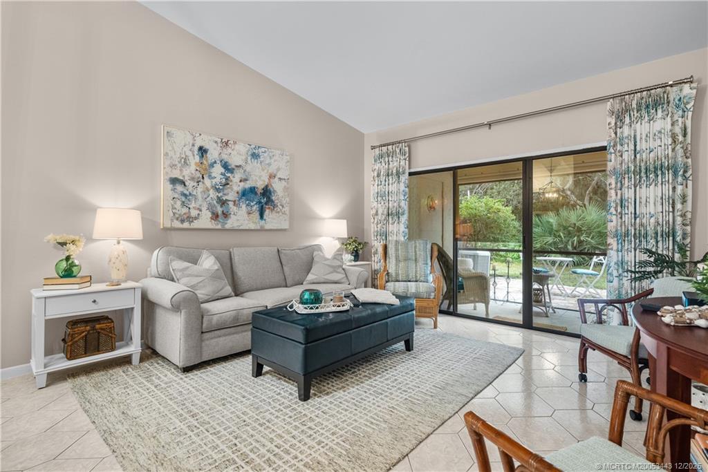 1544 Southwest Silver Pine Way, Unit 104F Palm City, FL 34990 - Photo 20 of 49 a living room with furniture and a floor to ceiling window