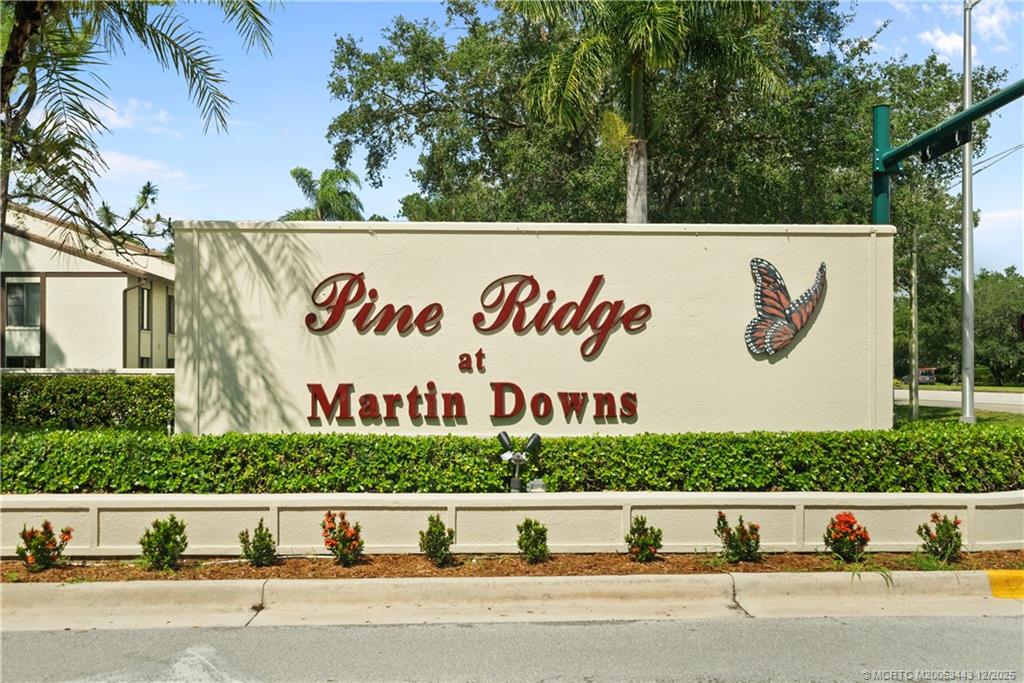 1544 Southwest Silver Pine Way, Unit 104F Palm City, FL 34990 - Photo 2 of 49 a view of a street with a sign board