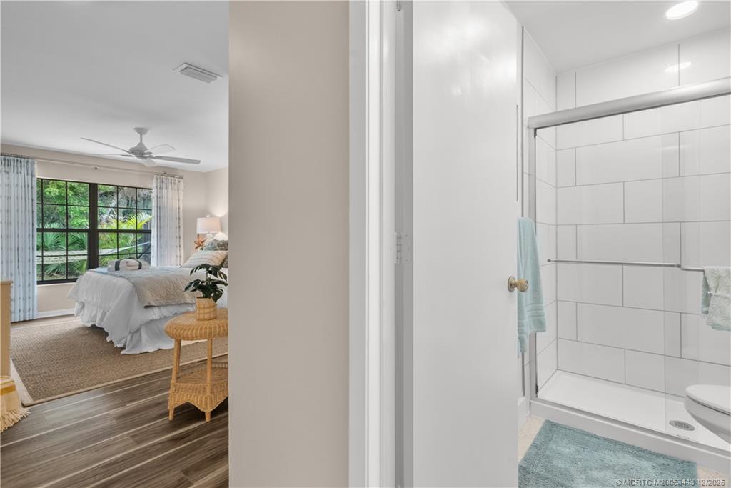 1544 Southwest Silver Pine Way, Unit 104F Palm City, FL 34990 - Photo 23 of 49 a room with a baby crib furniture and a window