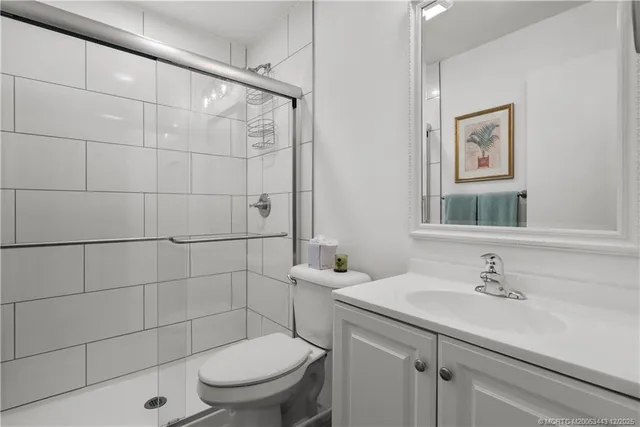 a bathroom with a sink toilet and a mirror