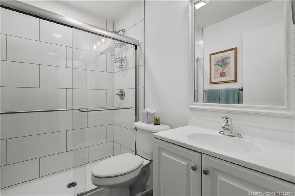 1544 Southwest Silver Pine Way, Unit 104F Palm City, FL 34990 - Photo 24 of 49 a bathroom with a sink toilet and a mirror