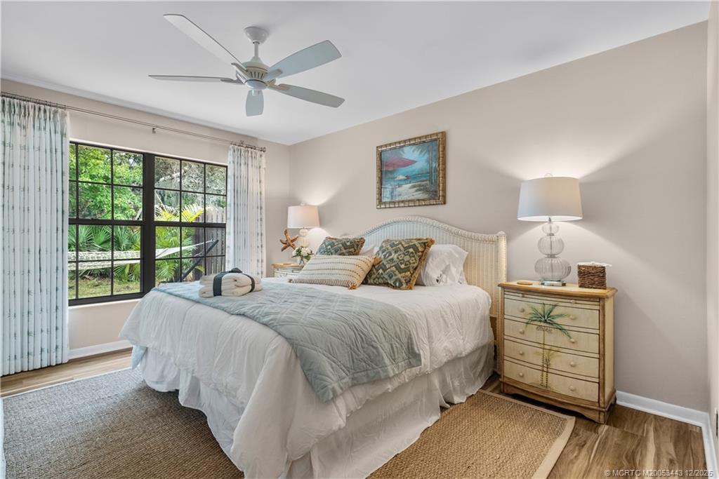 1544 Southwest Silver Pine Way, Unit 104F Palm City, FL 34990 - Photo 25 of 49 a bedroom with a large bed and a window