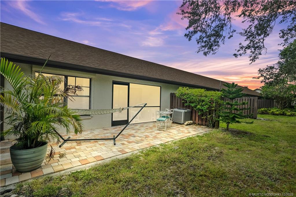 1544 Southwest Silver Pine Way, Unit 104F Palm City, FL 34990 - Photo 30 of 49 a view of a backyard with plants and a patio