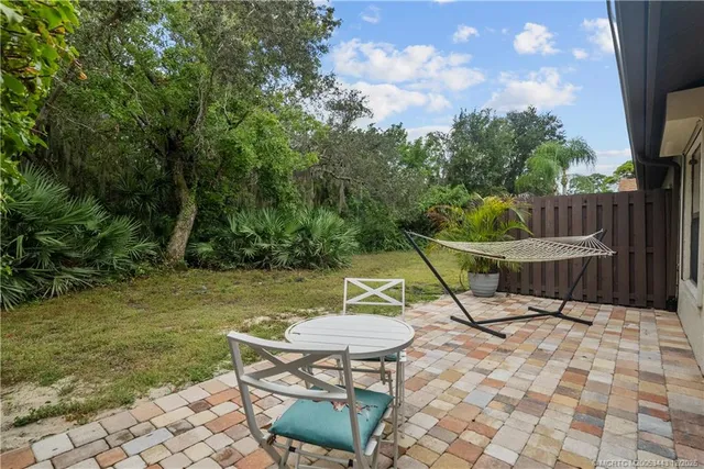 a view of a chairs and table in the patio