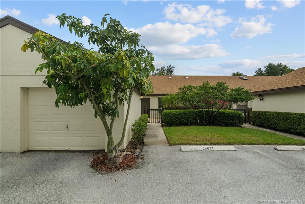 1544 Southwest Silver Pine Way, Unit 104F Palm City, FL 34990 - Photo 35 of 49 a view of backyard with green space