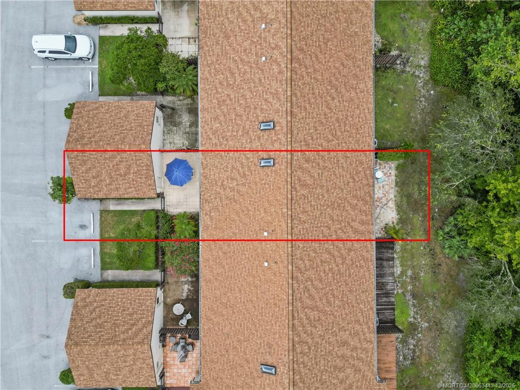 1544 Southwest Silver Pine Way, Unit 104F Palm City, FL 34990 - Photo 4 of 49 an aerial view of a house with a yard