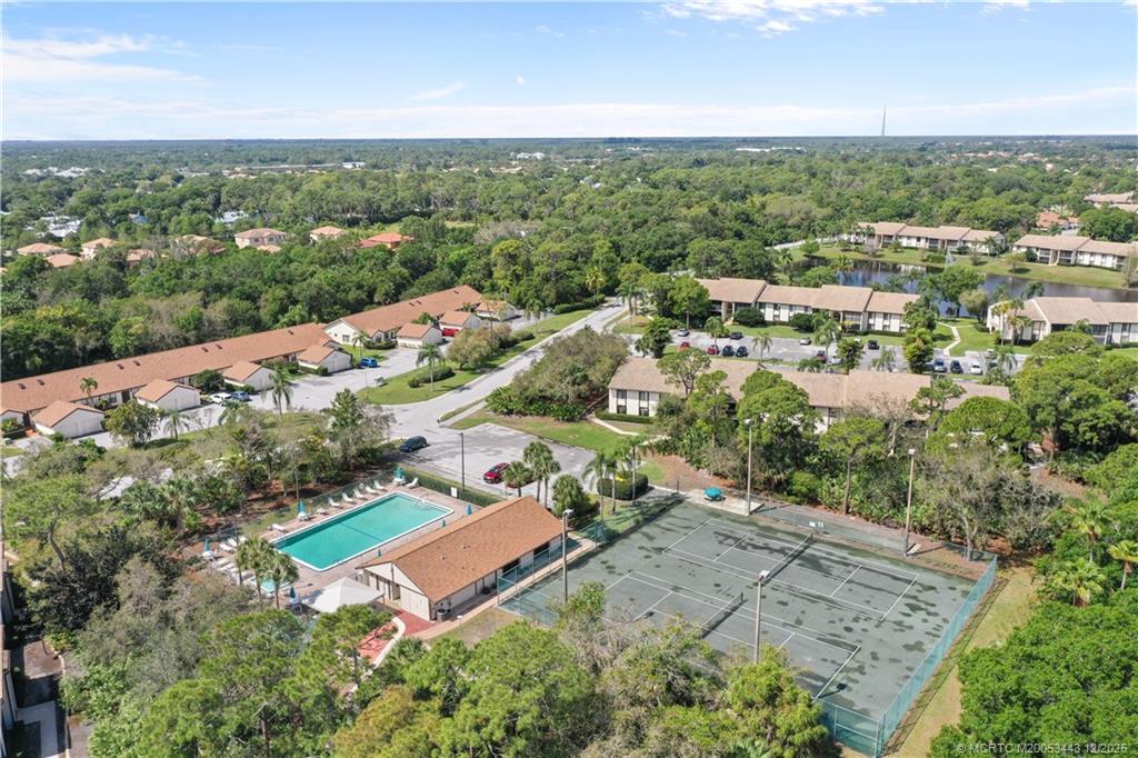 1544 Southwest Silver Pine Way, Unit 104F Palm City, FL 34990 - Photo 41 of 49 an aerial view of a city with lots of residential buildings