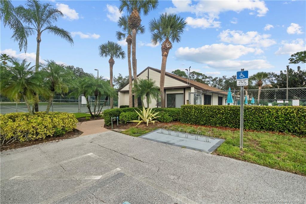 1544 Southwest Silver Pine Way, Unit 104F Palm City, FL 34990 - Photo 47 of 49 a front view of a house with garden