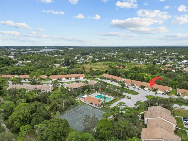 an aerial view of residential houses with outdoor space and street view