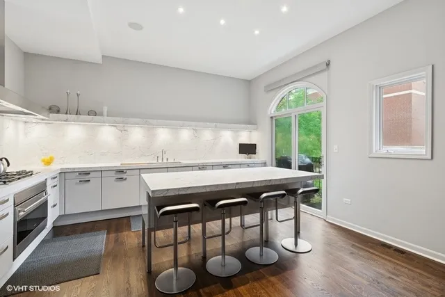 a kitchen with stainless steel appliances granite countertop a stove a sink and a refrigerator