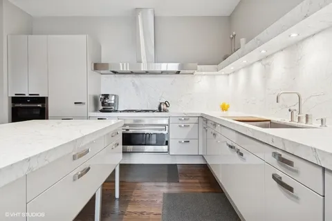 a kitchen with stainless steel appliances a sink stove and cabinets