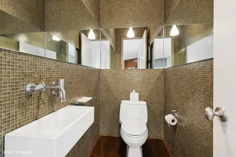 a bathroom with a toilet sink and mirror