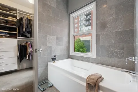 a bath tub sitting next to a window
