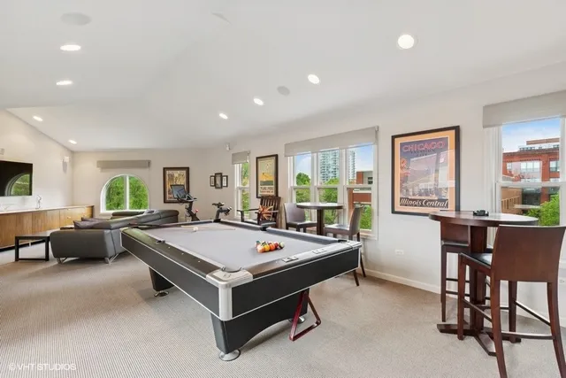 a room with pool table and windows