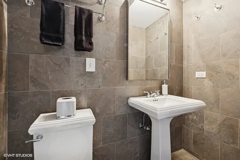 a bathroom with a sink a toilet and mirror